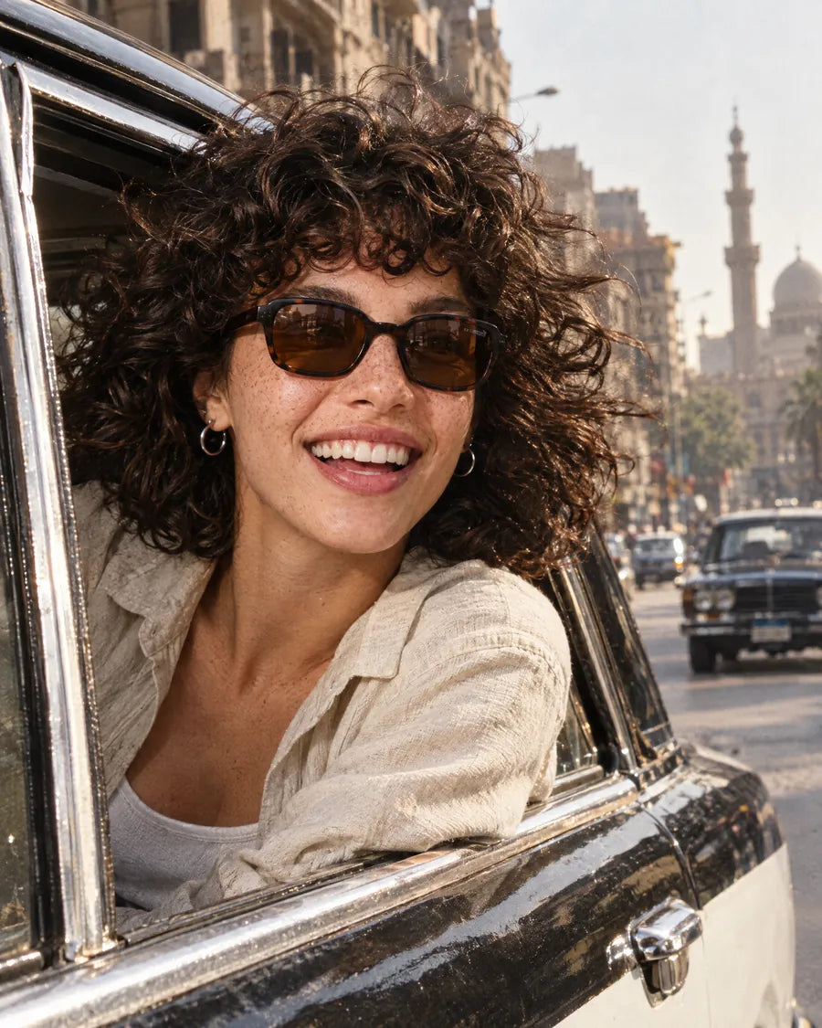 From El Banat: a girl in havana MT003 sunglasses at a taxi window downtown