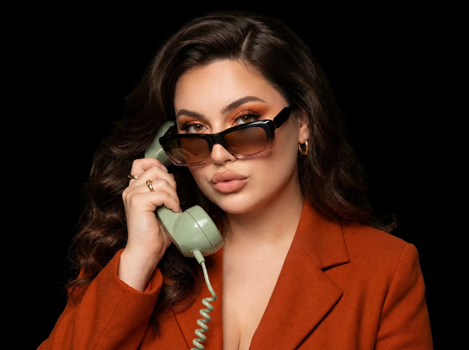 Woman wearing El Gareea in black rose, holding a vintage phone